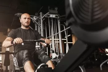 rowers hands gripping the handle of a rowing machine