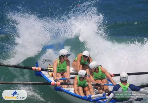 Olympic Rower Rachael Taylor paddling with her team through enormous waves in surf boat rowing, Australia