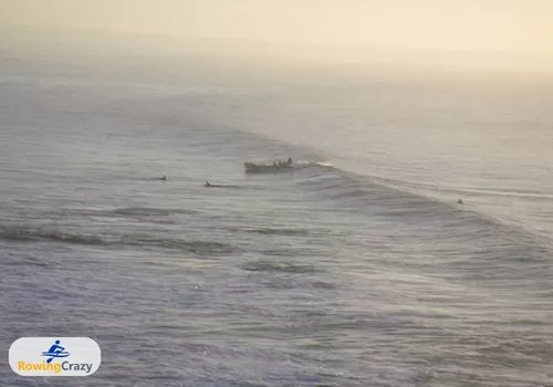 Rachael Taylor's team out in a surf boat at Torquay Point, Victoria, catching winter waves