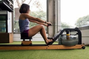 woman training with an indoor water rower